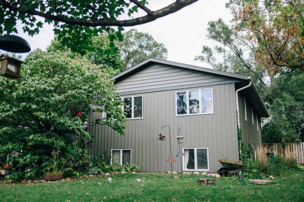 Split-level home with green siding and white trim