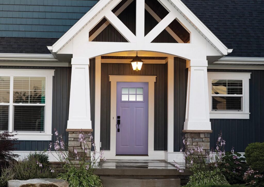 Front door entry with decorative trim and covered porch