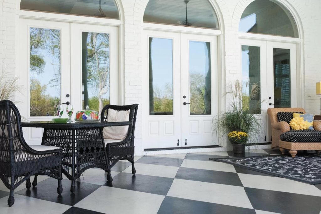 Sunroom with black-and-white tile floor and large windows