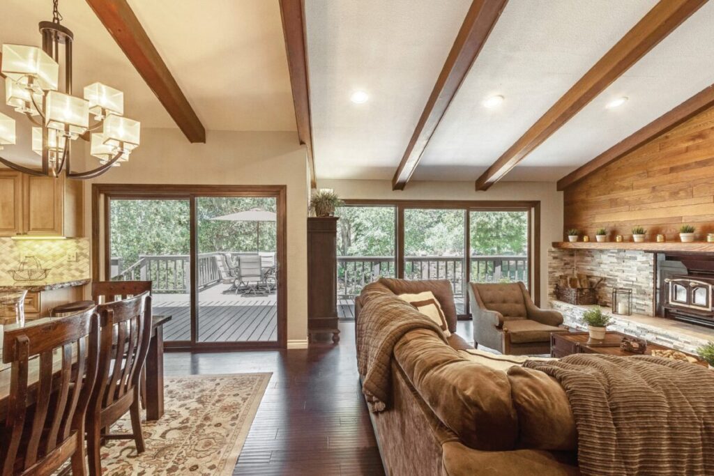 Interior living room with wood beams and large windows