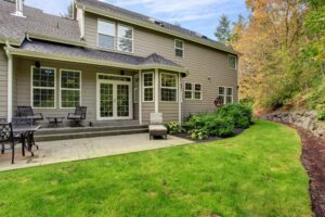 A large tan home with new siding and windows