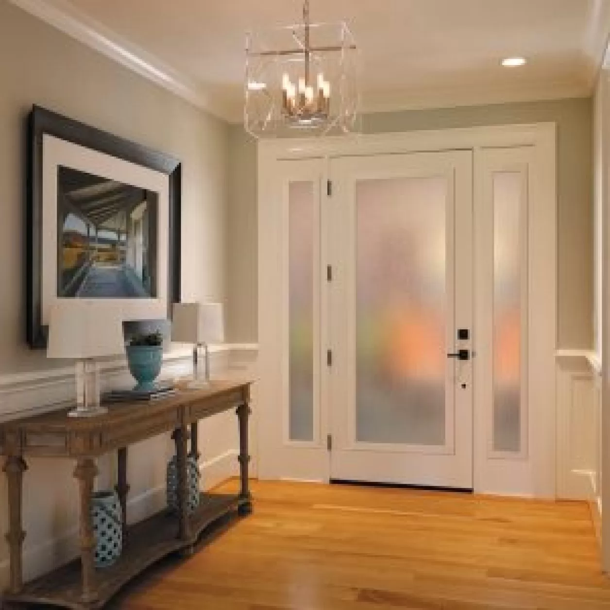 An entryway in a home with white doors featuring large, long windows