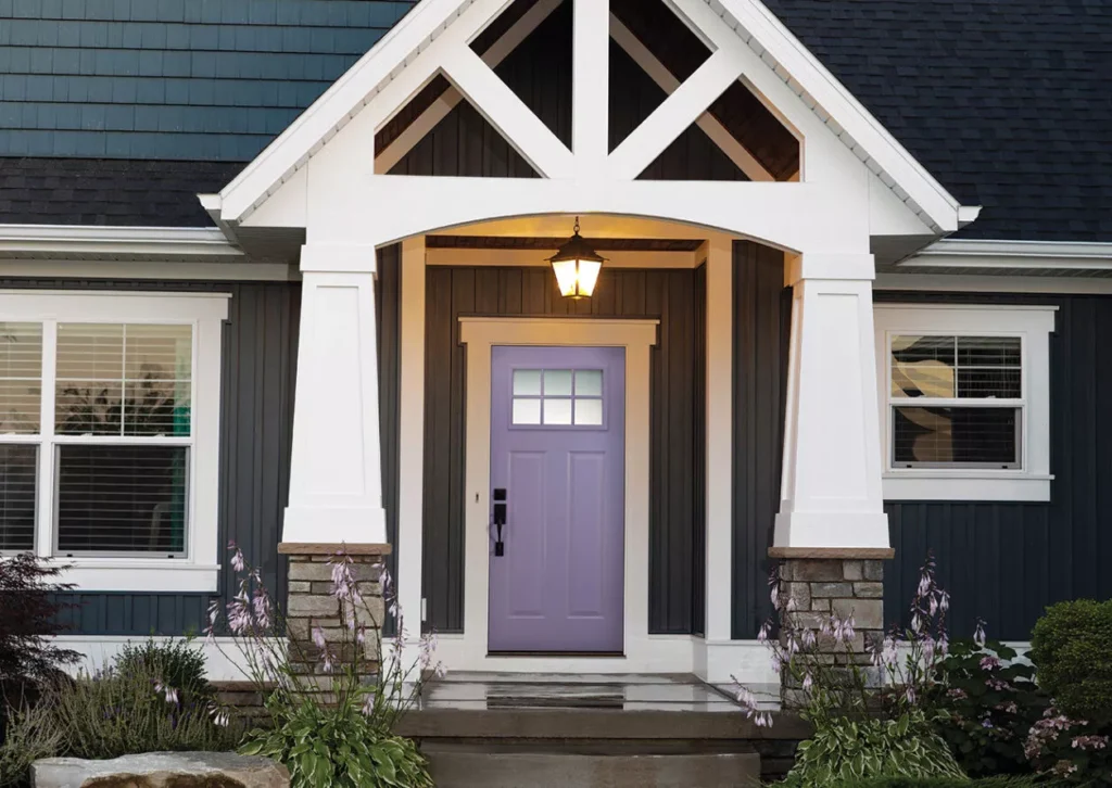 Front door with decorative trim and covered entry
