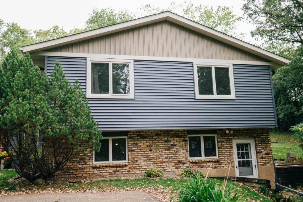 Split-level home with gray siding and white trim