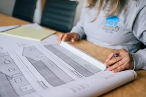 A C&T Siding & Windows worker looking at a house plan