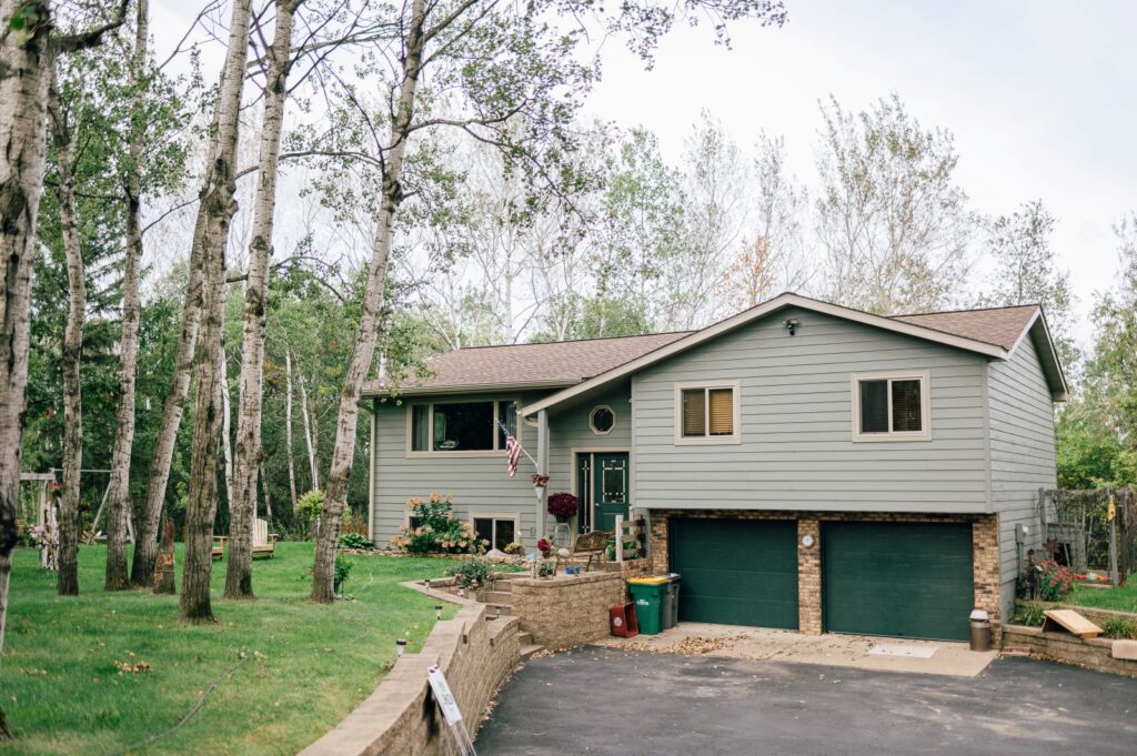 Home exterior with green siding and covered porch