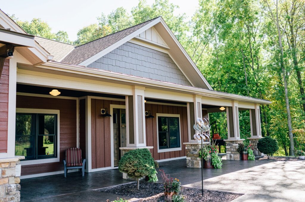 Craftsman-style home with wood accents, covered porch, and stone details