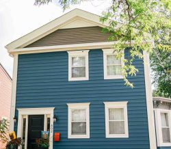 Two-story blue home with white trim